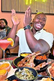 Guests sharing brunch and drinks at The Greedy Lion
